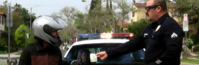 Good guy cop pranks people by pulling them over to give them $100