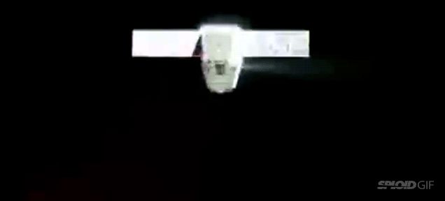 Dragon spacecraft quickly firing thrusters to adjust course