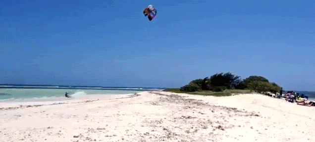 Watch this guy jump over an entire island while kitesurfing
