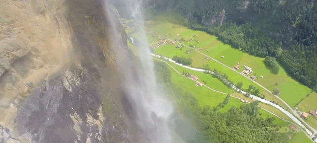 Mad man in a wingsuit flies through a waterfall