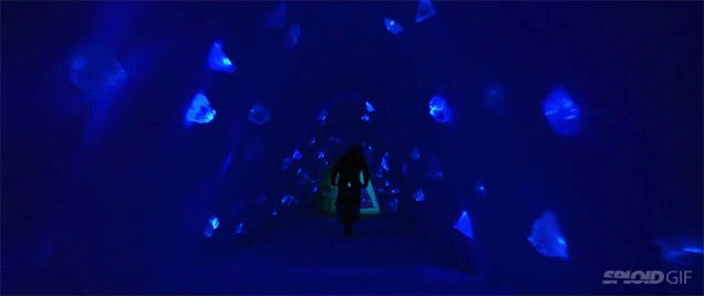 Riding a motorcycle in this ice cave looks like exploring an alien world