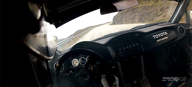 Mad race driver drifting near a cliff on a mountain pass