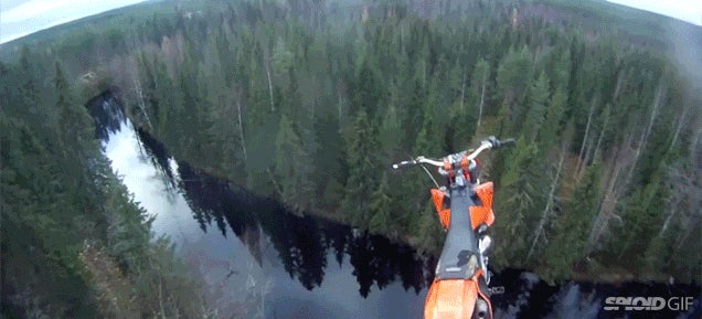 Daredevil jumps off his flying motorcycle and parachutes into a river