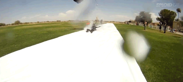 Skydivers land on a Slip 'n Slide after jumping from 5,000 feet
