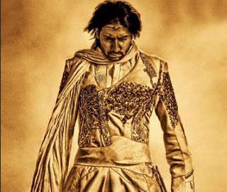 Only One Man Can Pull Off A Gold Superhero Costume, And Save The Universe