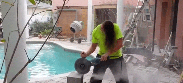 Fun guy spins his head like a metal rock star while doing construction