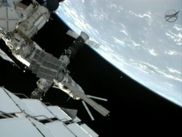 Spacewalking cosmonauts heave a 20-pound metal ball into Earth orbit
