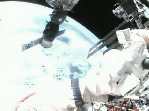 Spacewalking cosmonauts heave a 20-pound metal ball into Earth orbit