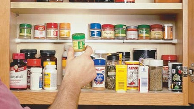 Use a Tension Rod To Create a Second Shelf in Your Kitchen Cabinet for Spices