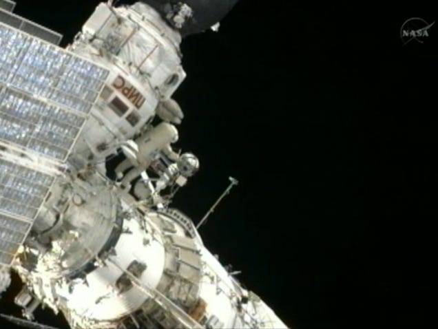 Spacewalking cosmonauts heave a 20-pound metal ball into Earth orbit