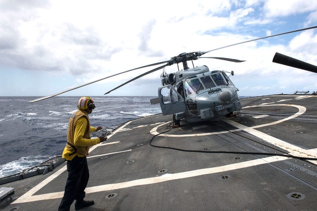 Crazy angle of a US Navy helicopter on a guided-missile cruiser