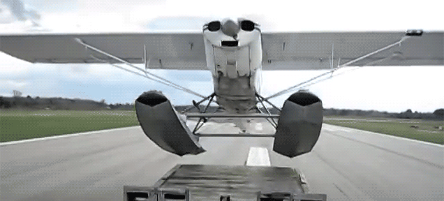 daredevil seaplane pilot takes off from a towed truck trailer