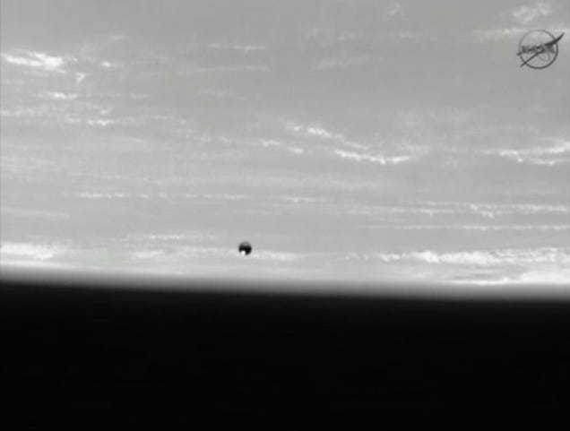 Spacewalking cosmonauts heave a 20-pound metal ball into Earth orbit
