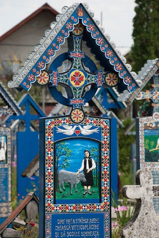 In the world's most cheerful cemetery, the tombstones are brightly painted and jokes are written on the graves