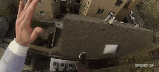 Guy jumps off a building, slides down a roof and lands on stairs for fun