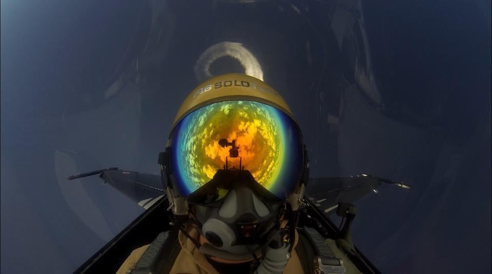 The whole world seems reflected on this F-16 pilot diving back to Earth