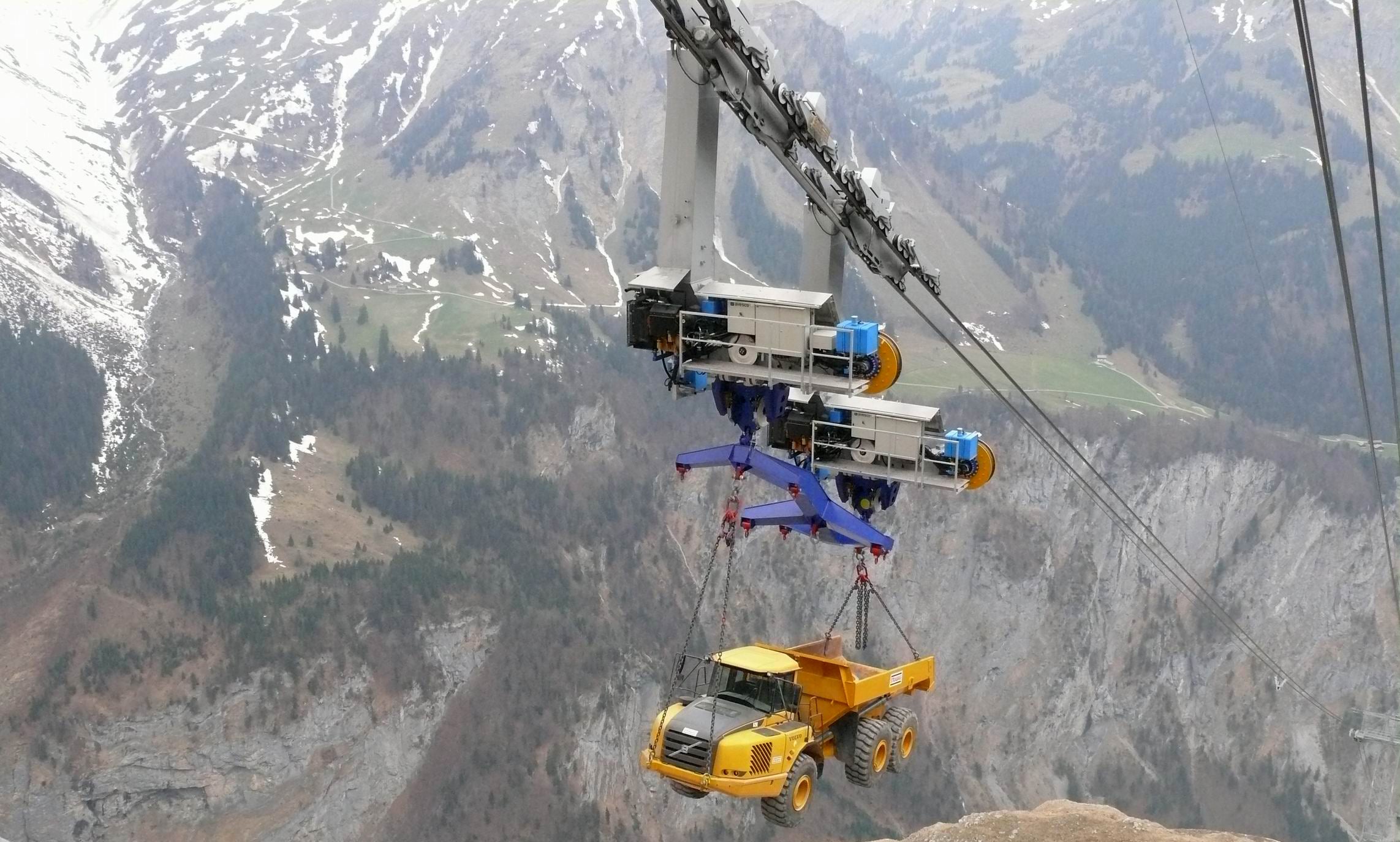 Truck transported on a ropeway going up a 5,400-foot mountain