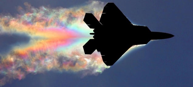 F-22 Raptor makes a rainbow as sunlight diffracts on its vapor trail