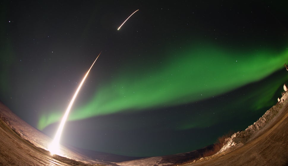A rocket shoots directly into the heart of an Alaskan aurora