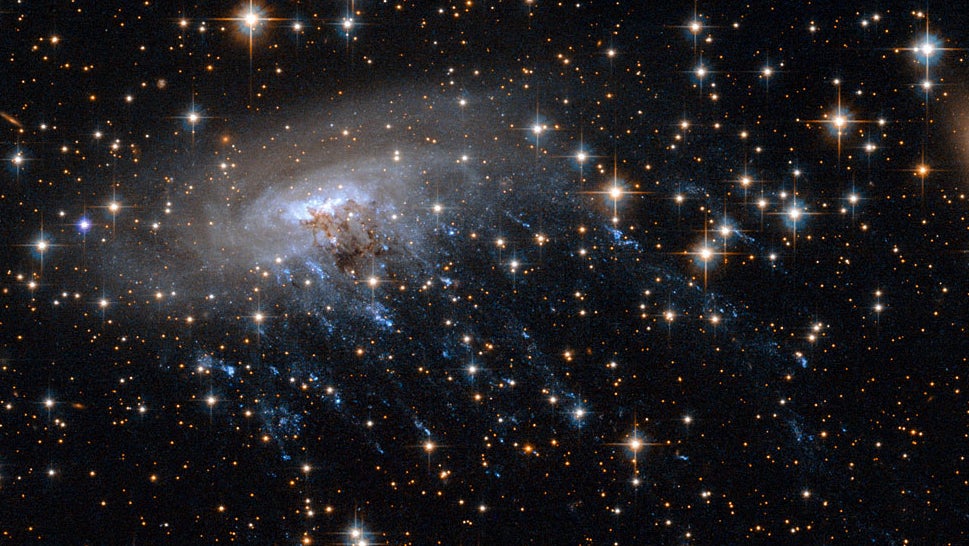 Haunting new Hubble image shows a galaxy being ripped to shreds