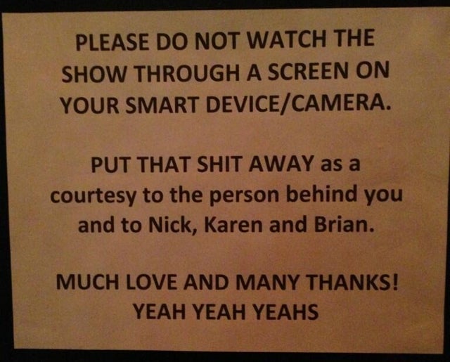 Yeah Yeah Yeahs Post Sadly Necessary Sign Asking Fans Not to Watch Their Show Through a Smartphone Screen