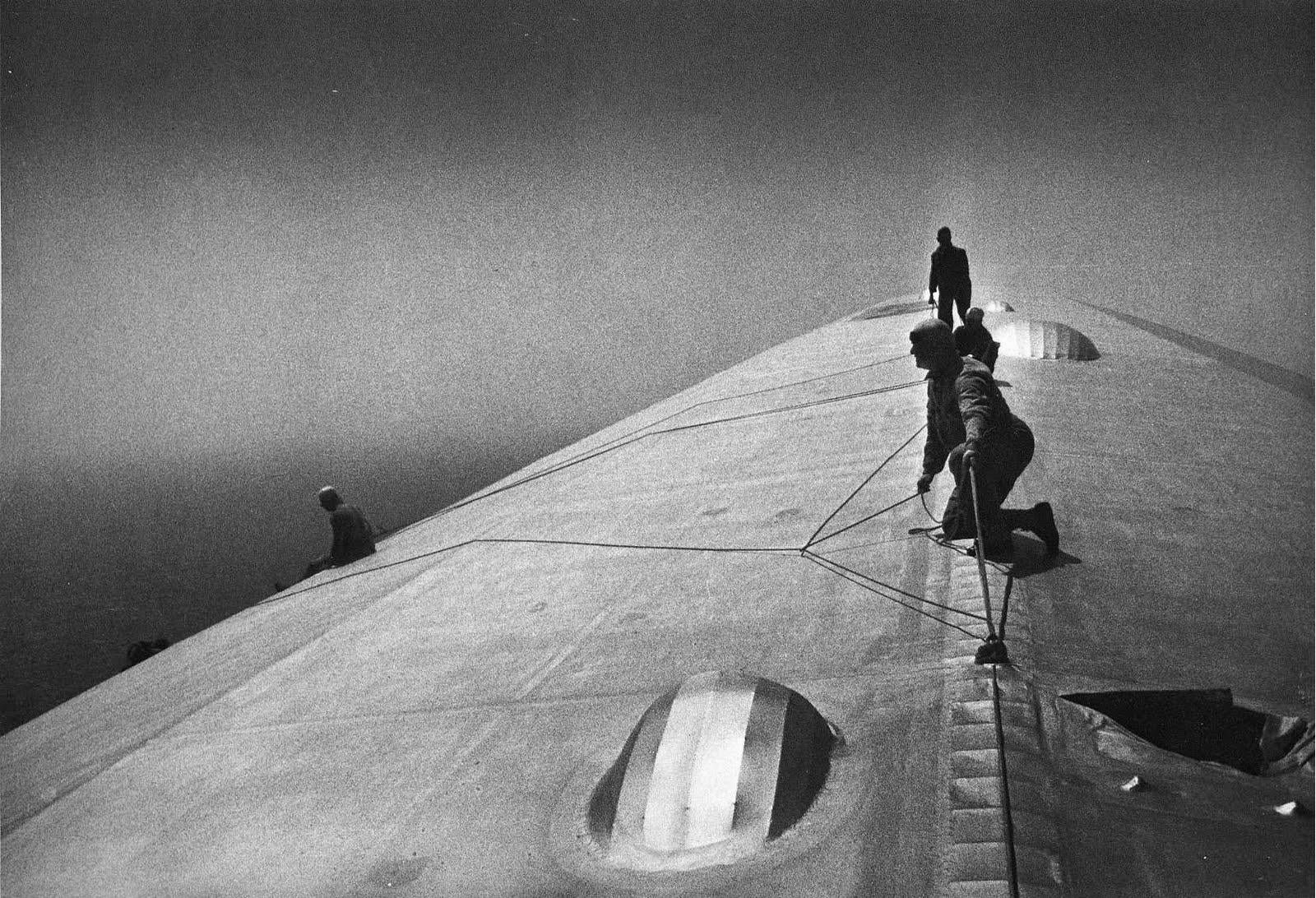 Daredevil men fixing a zeppelin in mid-flight over the Atlantic