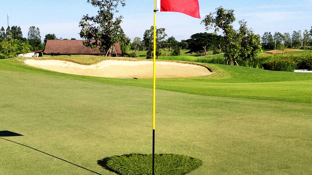 Golf Course Groundskeeper Leaves Triangle Of Longer Grass Above Hole Golf Course Groundskeeper Leaves Triangle Of Longer Grass Above Hole