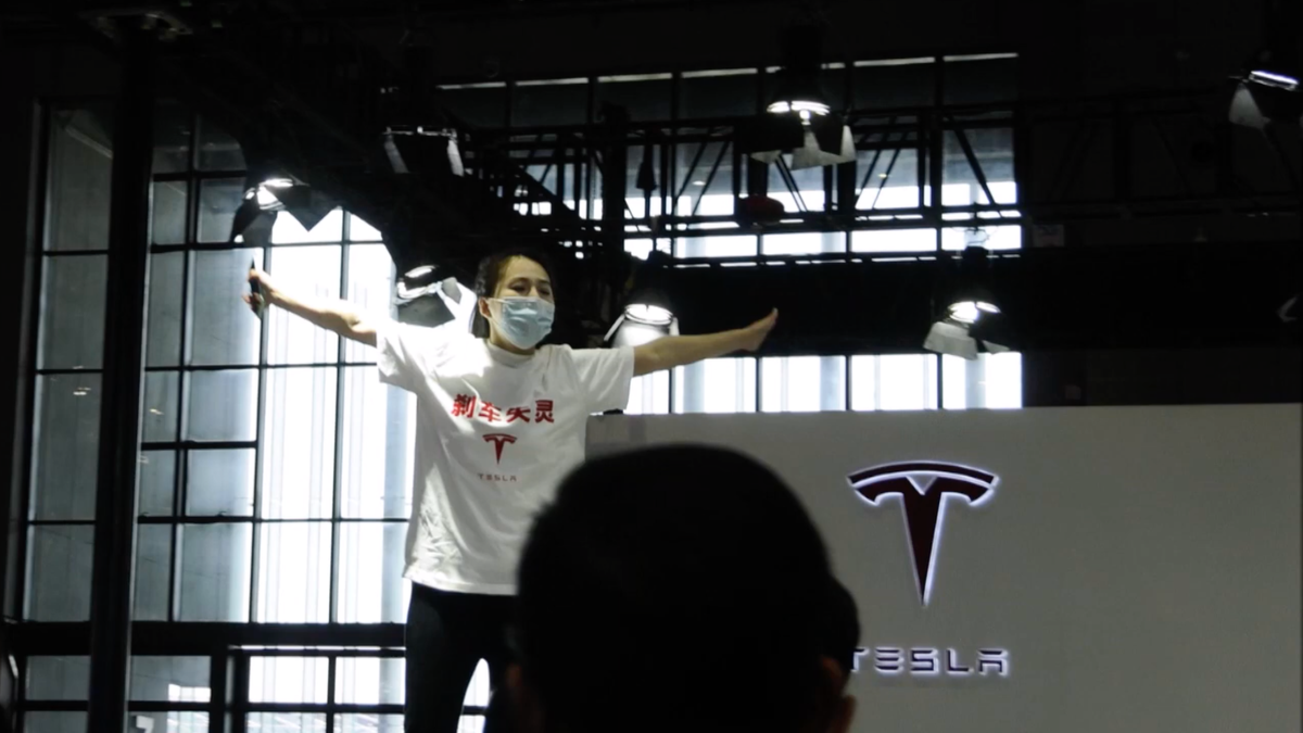 A Tesla protester was dragged out of the Shanghai Motor Show