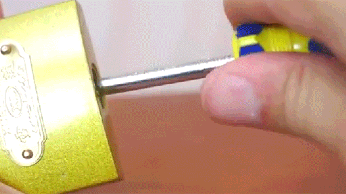 Breaking Open A Lock With A Paper Clip A Screwdriver Or A
