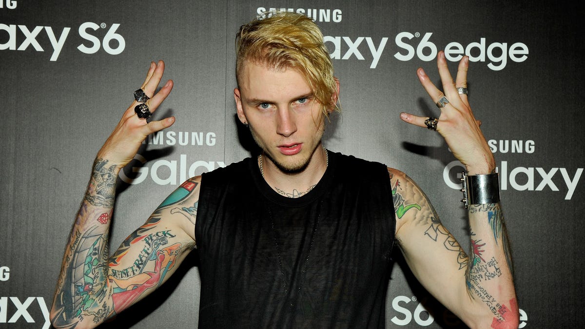 Watch Machine Gun Kelly dance on a boardroom table in front ...