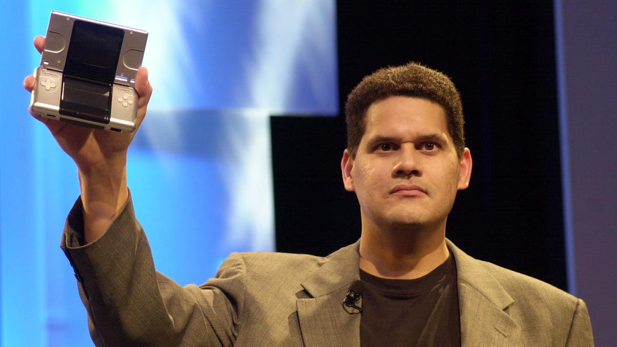 Reggie Fils-Aime brandishes a Nintendo DS.