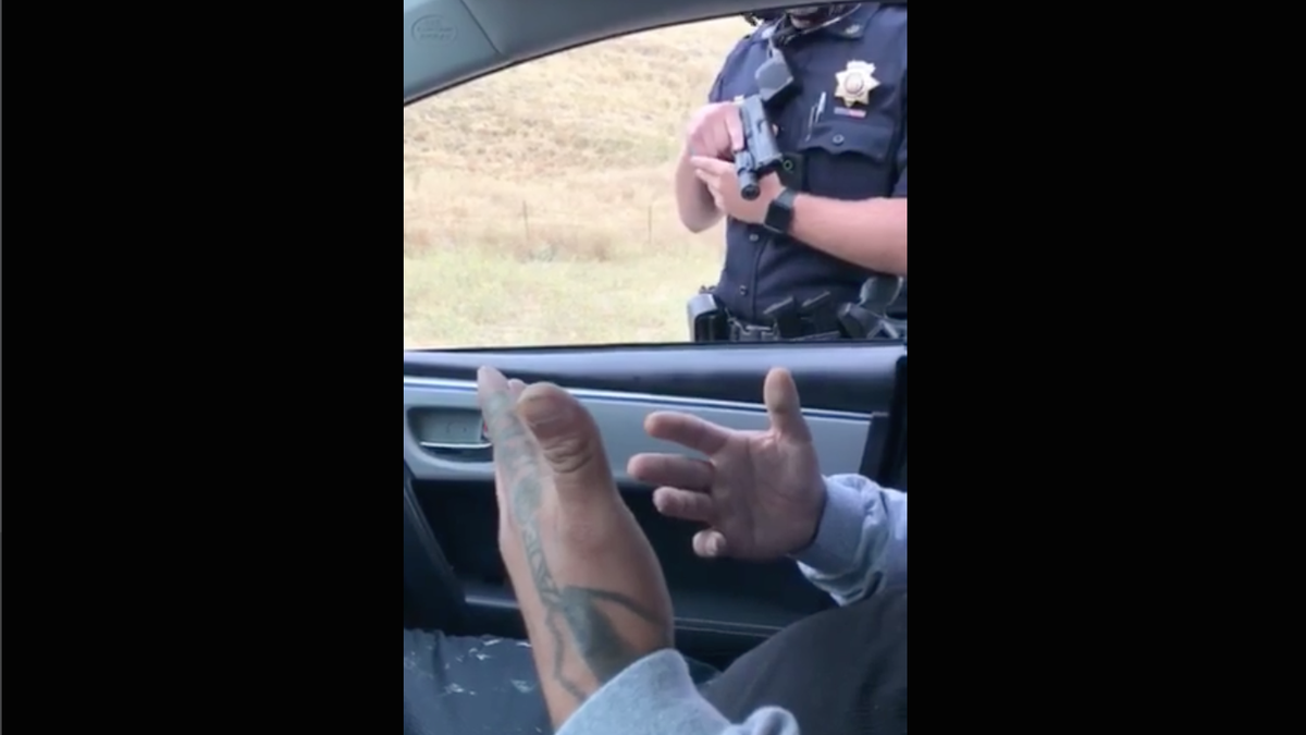 cop pointing gun stock photo