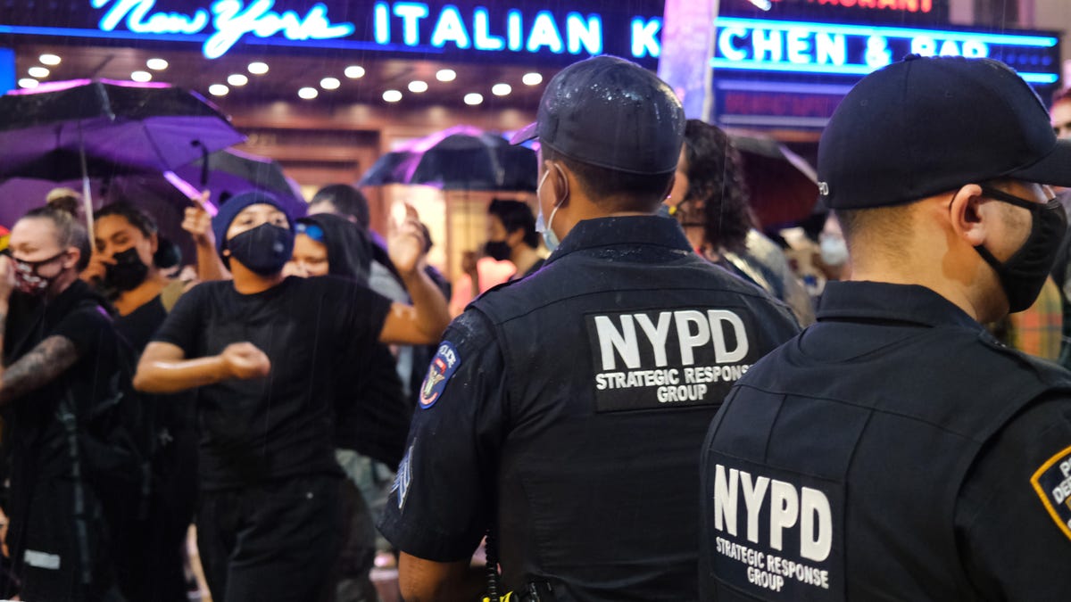 Last night, New York City police were filmed in Times Square, gently ushering Black Lives Matter counter-protesters into the back of a black  sedan, which very much resembled a police cruiser, with New York plates. The same car almost immediately plowed throu…