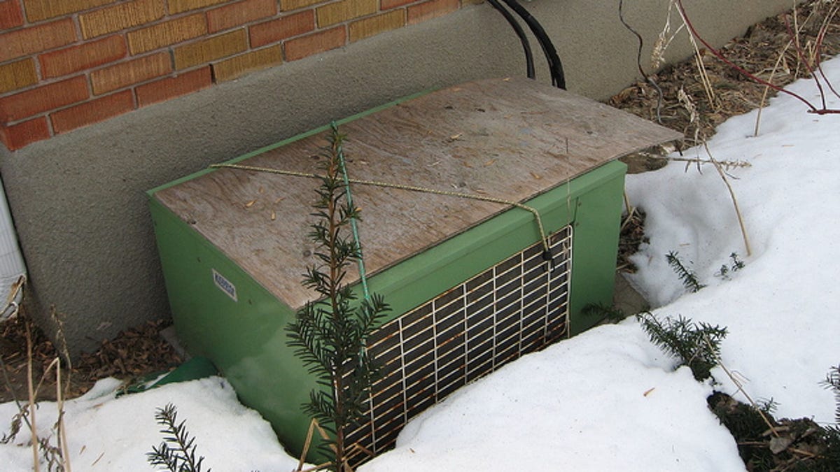 Cover Your Air Conditioner With Plywood To Protect It For The Winter