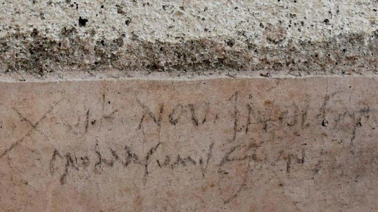 Graffiti, likely scribbled by a construction worker millennia ago in Pompeii.