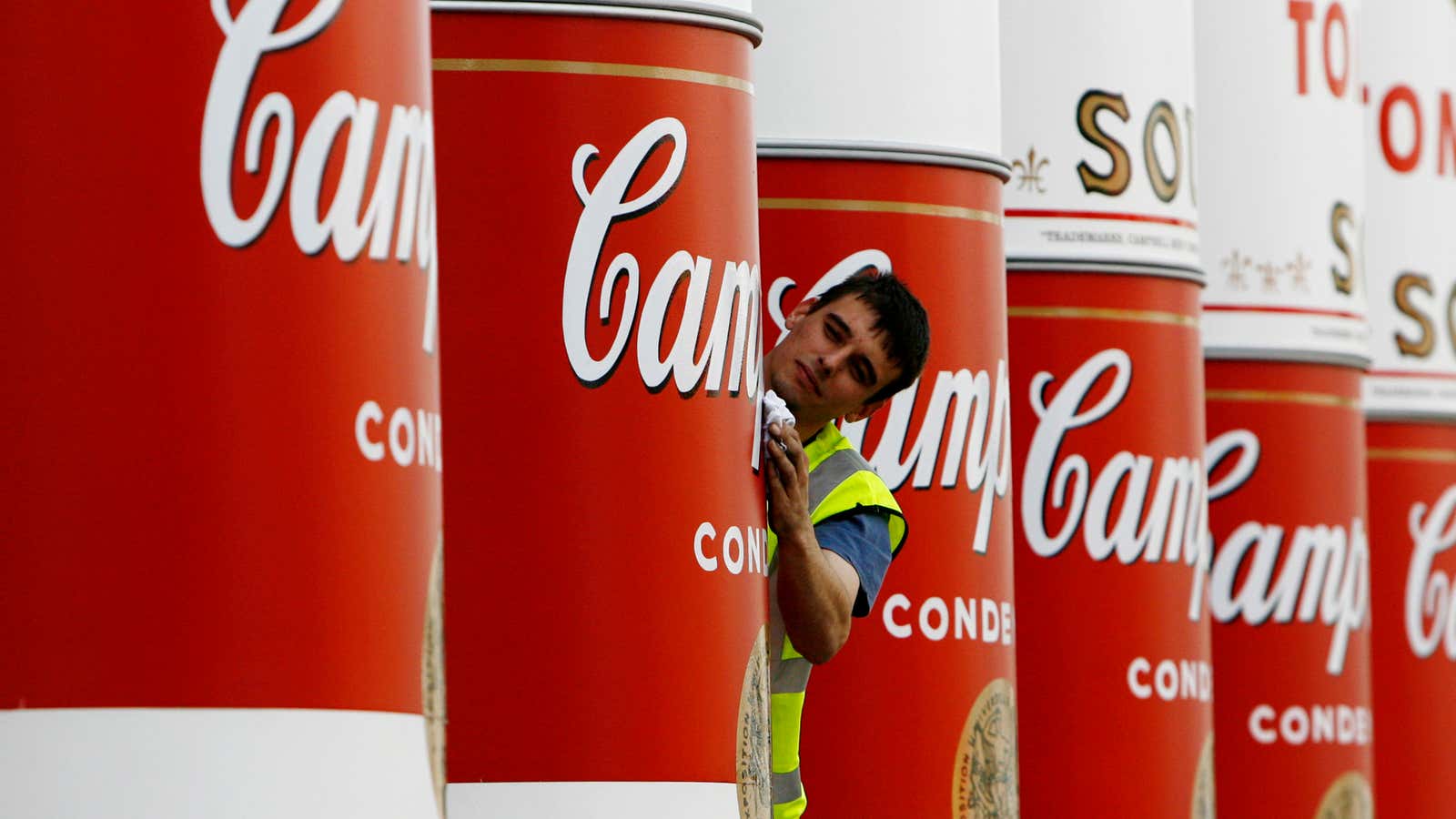 A workman wipes the main pillars of the National Gallery of Scotland complex, that were unveiled to show an Andy Warhol â€˜Campbellâ€™s Soup cansâ€™ artwork covering,  Edinburgh, Scotland July 31, 2007. The pillars were decorated to promote the Andy Warhol exhibition in Edinburgh which marks the 20th anniversary of the artistâ€™s death, and opens to the public on August 4.    REUTERS/David Moir   (BRITAIN)