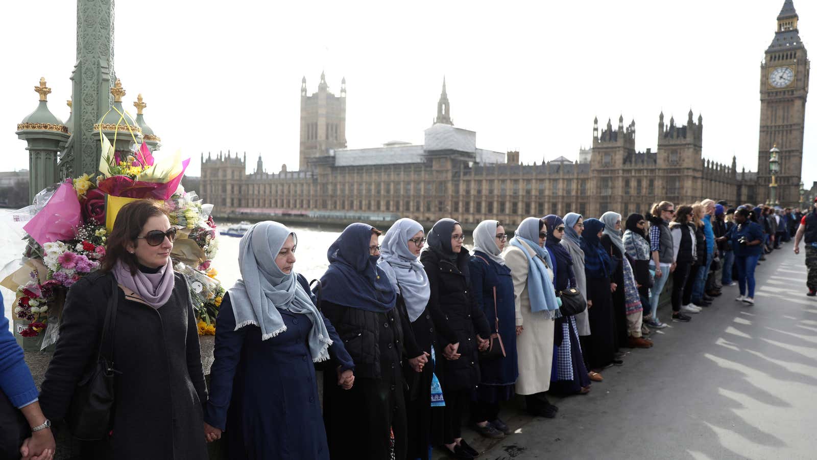 Participants in the Women’s March, gather on Westminster Bridge to remember victims of the attack.