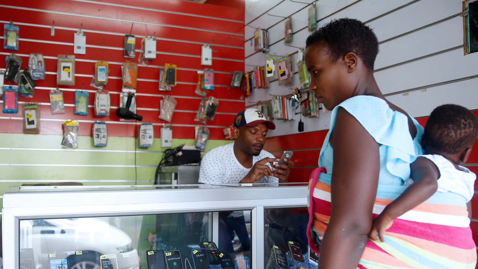 A woman looks at mobile phones at a shop in central Harare, Zimbabwe, December 12, 2017.