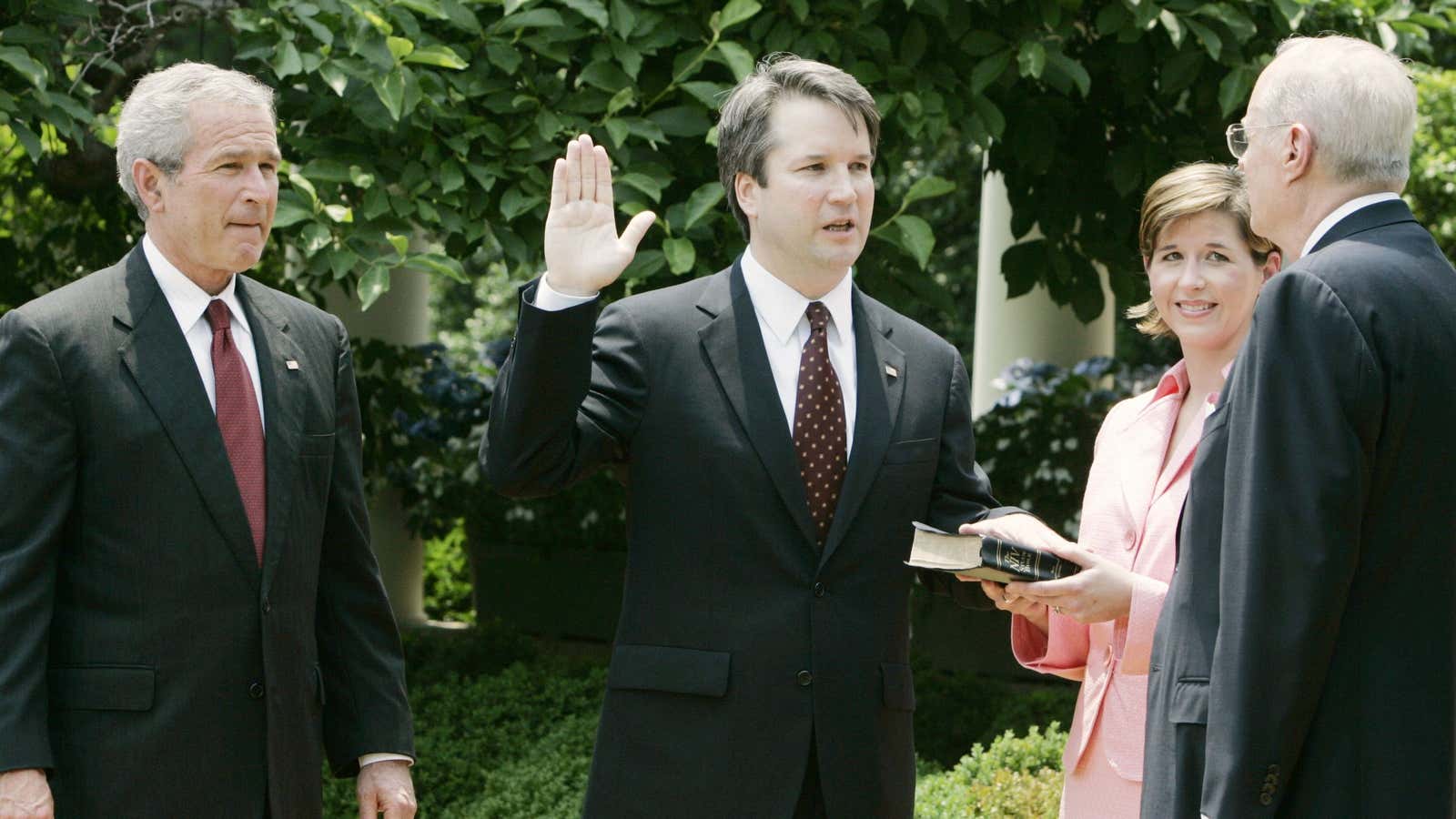 Kavanaugh is sworn in in 2006 as George W Bush watches.
