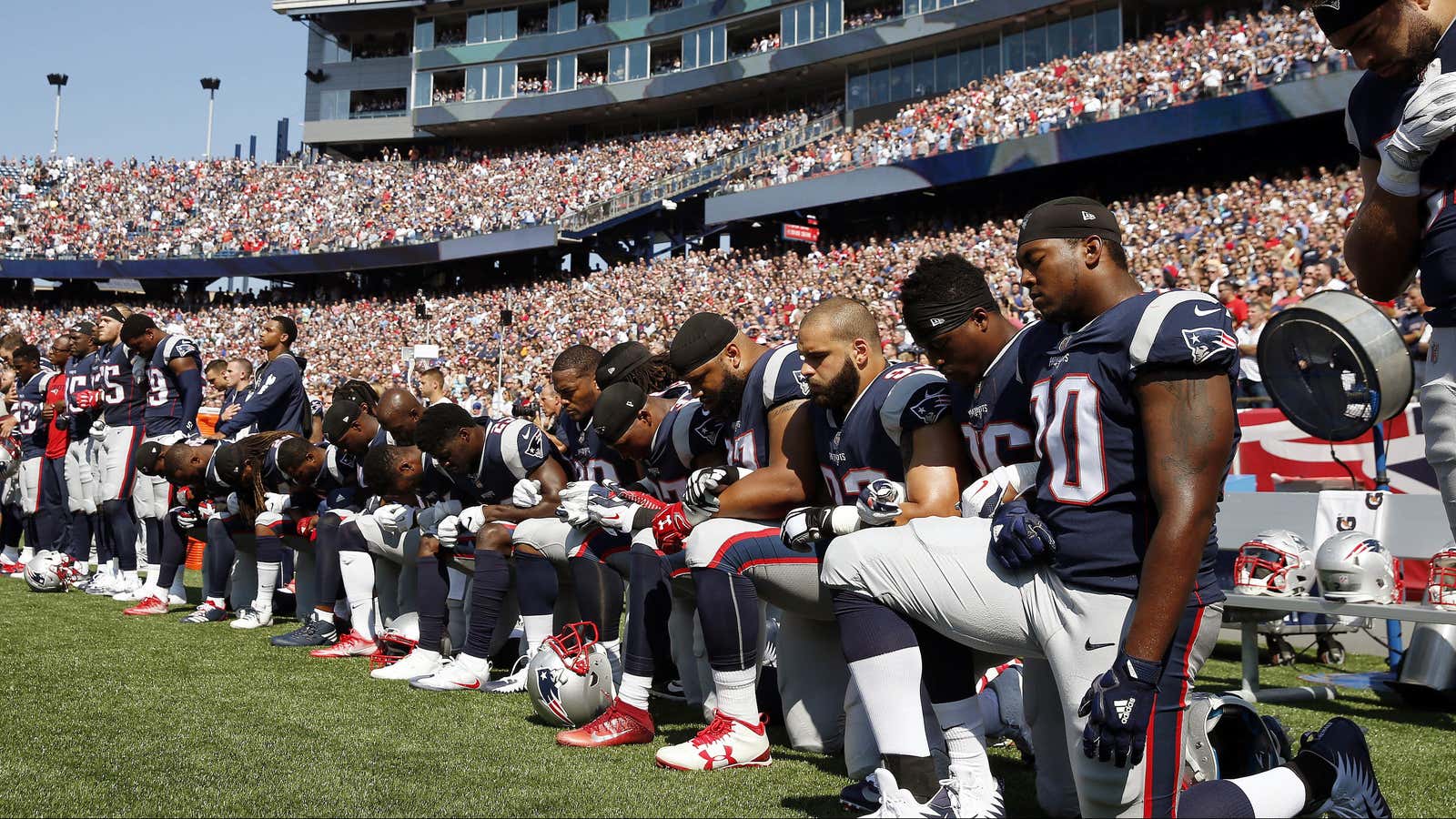 Members of the New England Patriots take a knee.
