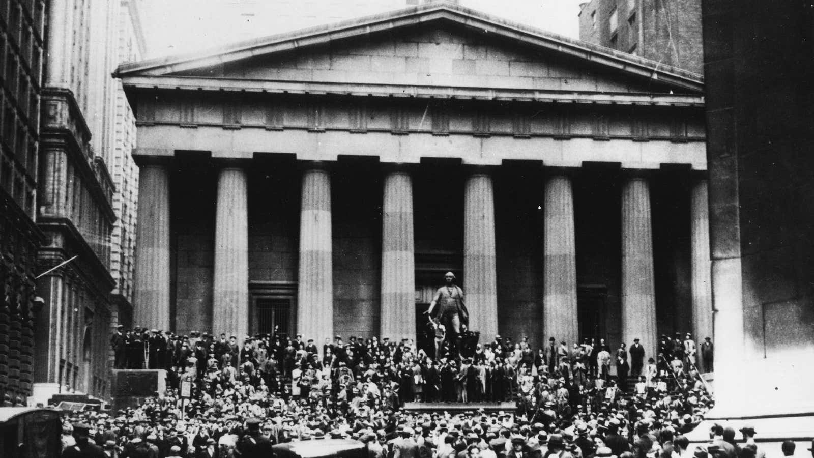 Crowds gather across the street from the New York Stock Exchange as the market crashed on October 24, 1929.