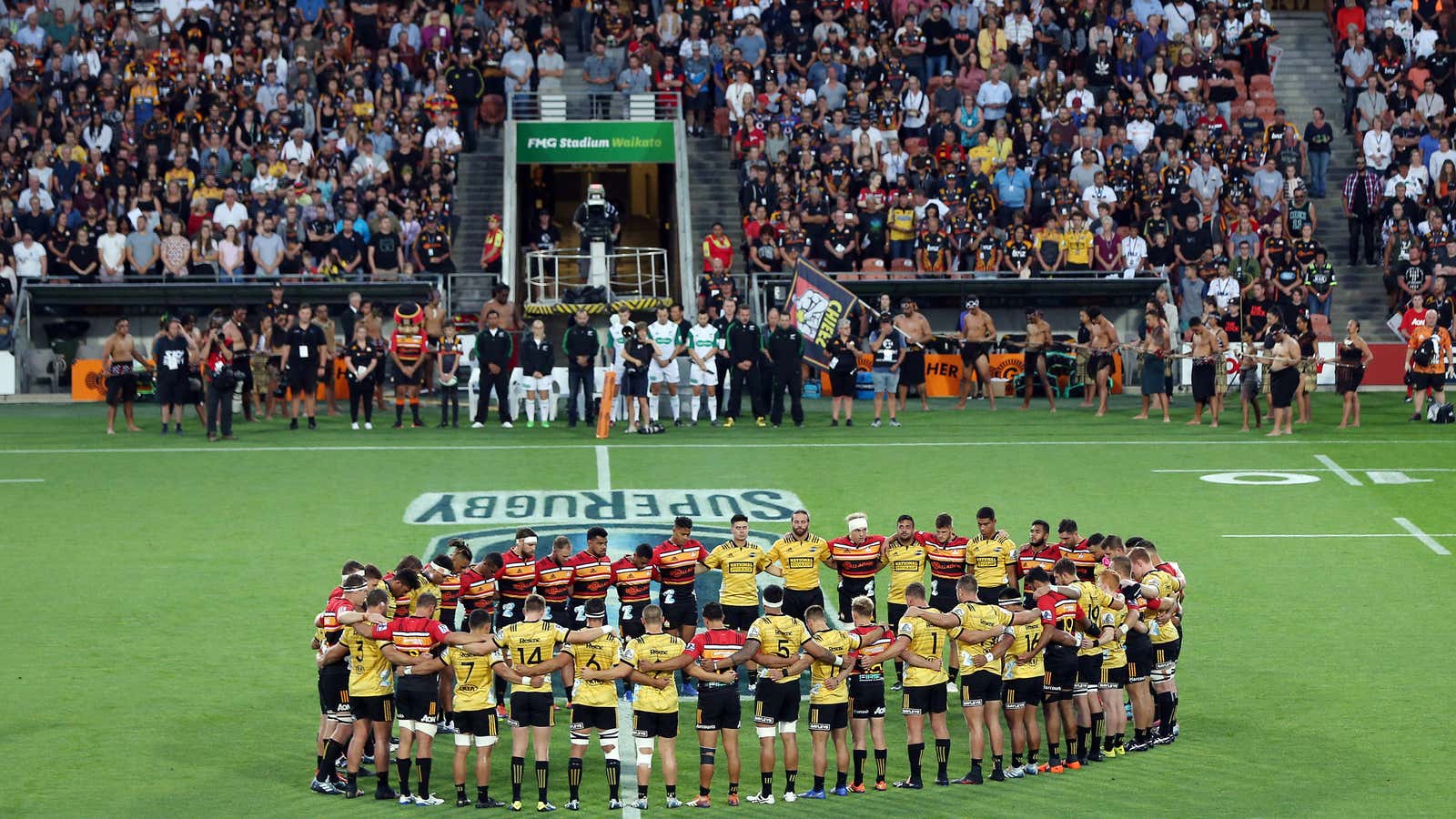 The Chiefs and Hurricanes come together for a moments silence prior to the round five Super Rugby match in Hamilton, New Zealand.