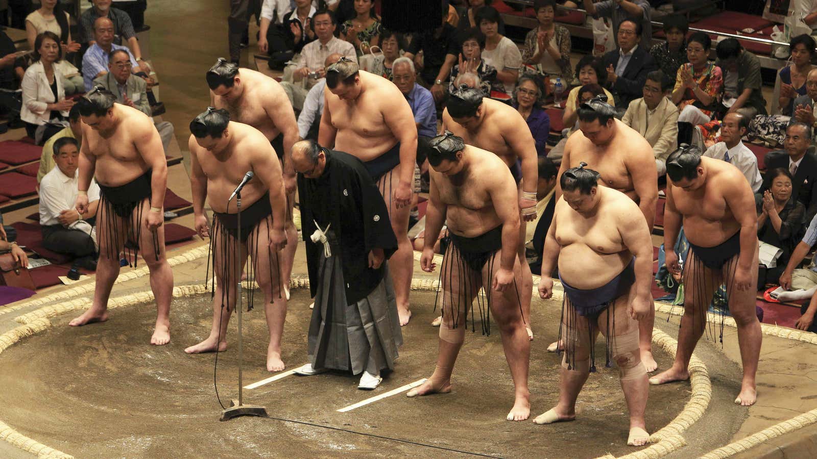 Sumo wrestlers bow in 2010 to apologize for the sport’s involvement with yakuza groups.