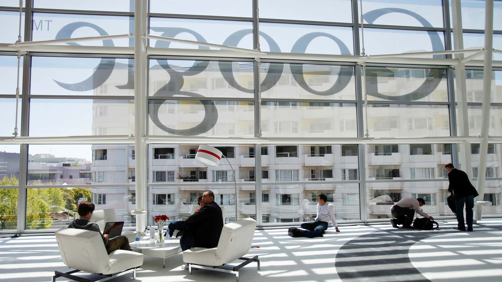 Attendees sits in front of a Google logo during Google I/O Conference at Moscone Center in San Francisco, California June 28, 2012.