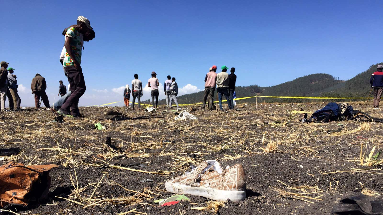 People walk at the crash scene