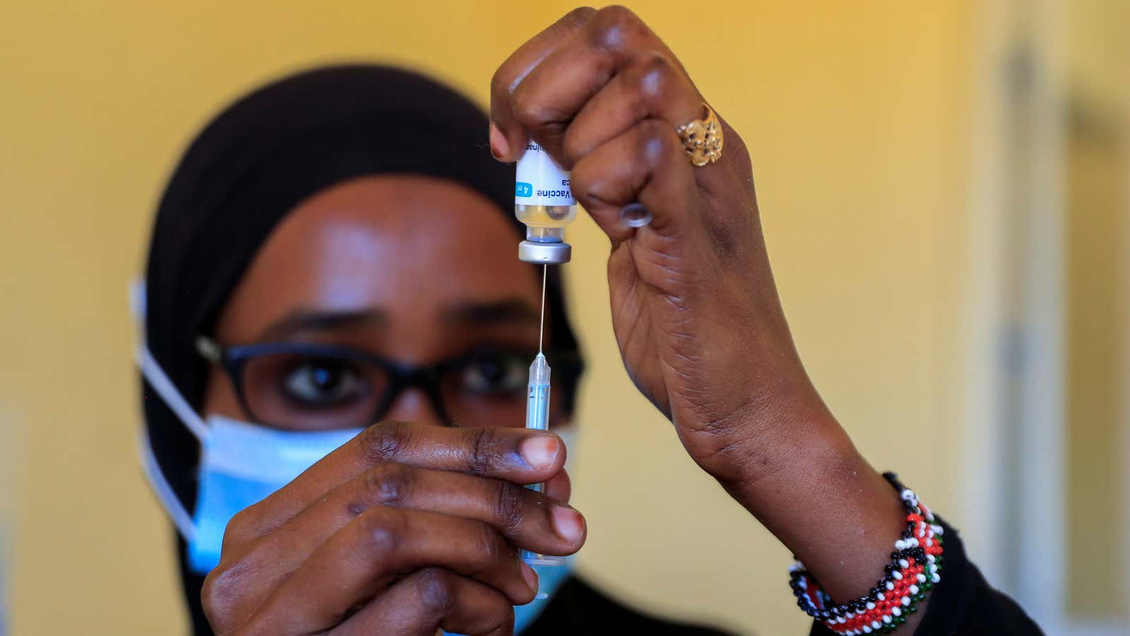 A nurse prepares to administer a covid-19 vaccine in Iibissil settlement in Kenya.