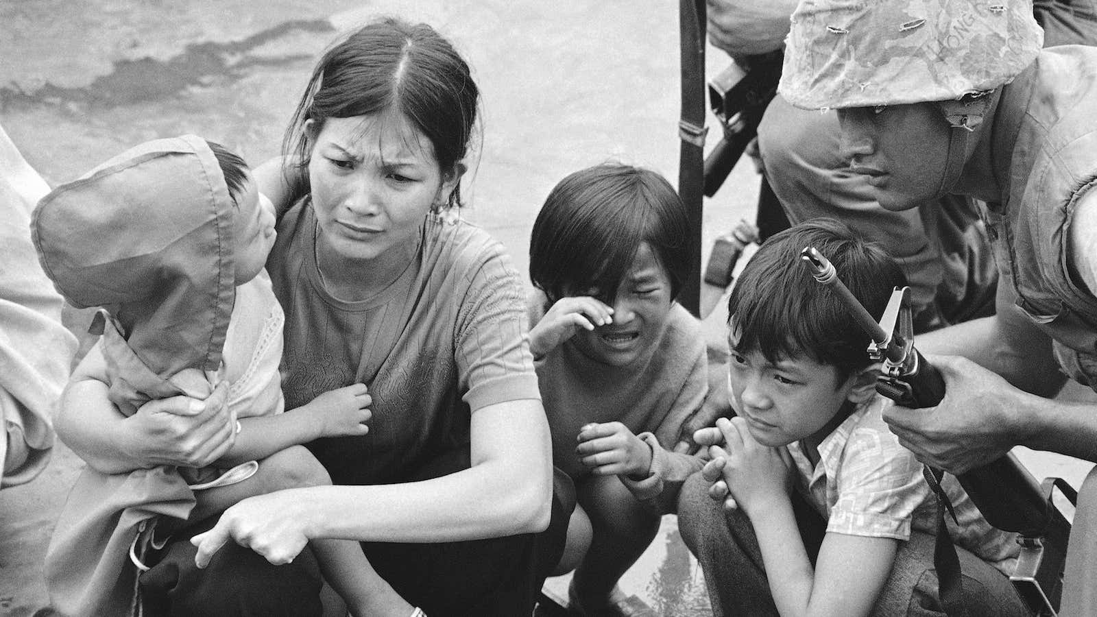 A South Vietnamese mother and her three children stand on the deck of an amphibious command ship being plucked out of Saigon by US Marine helicopters in Vietnam.