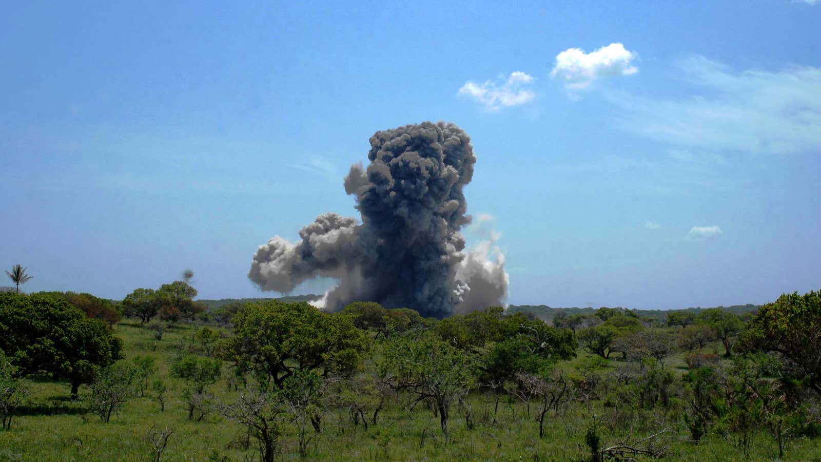 Smoke rises from the detonation of weapons and landmines left over from Mozambique’s civil war near Bilene in southern Mozambique in 2005.