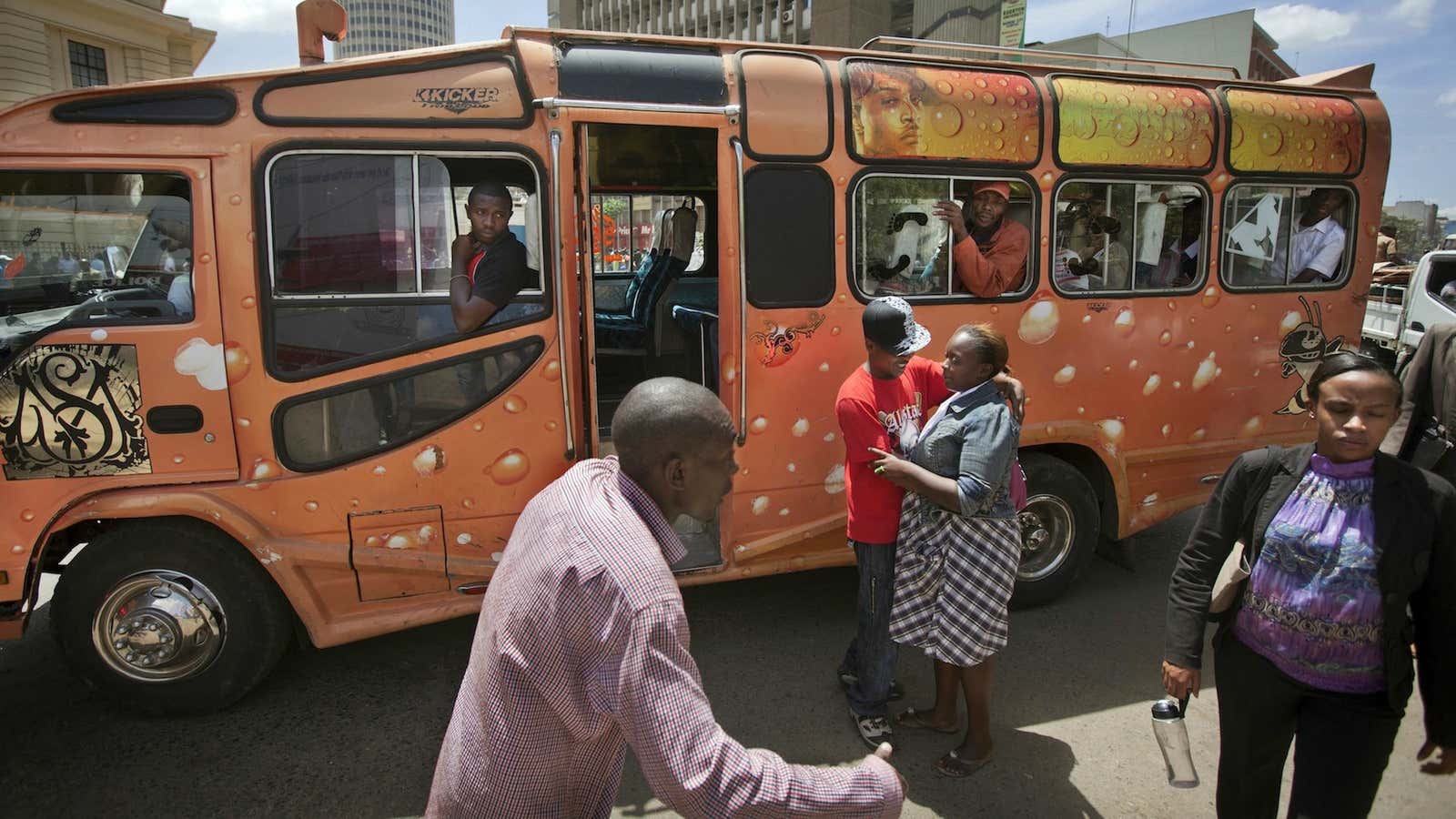 Matatu operators try to coax passengers on board their bus in Nairobi.