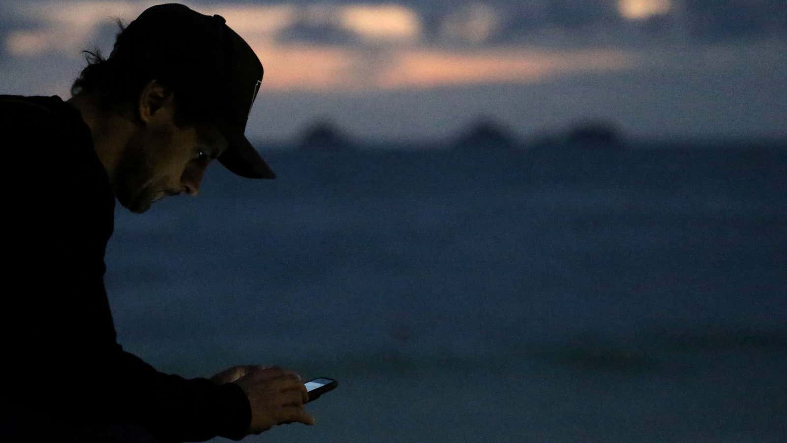 A man uses his phone in Rio.